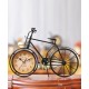 A desktop clock ornament in the shape of a bicycle with a delicate design