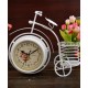 A desktop clock ornament in the shape of a bicycle with a delicate design